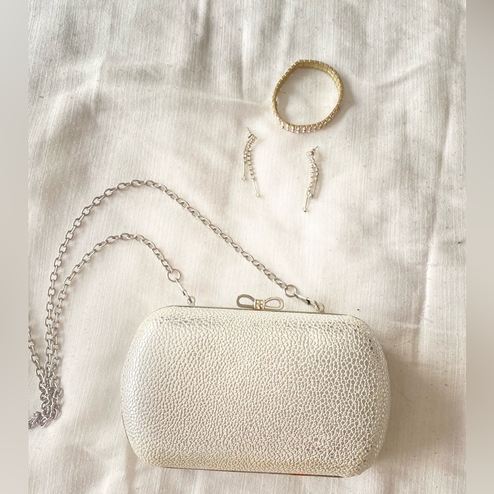 Claire’s silver clutch bag with earrings and bracelet